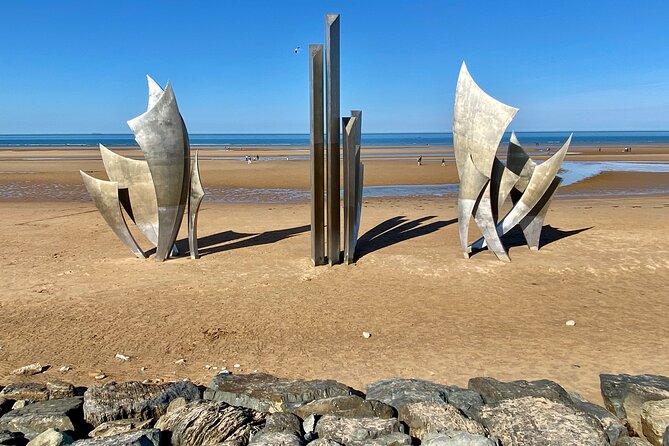 Private Normandy D-Day Live guided Top 6 Sites trip from Paris - Overlord Museum + Omaha Beach: artifacts, vehicles, and the sense of scale